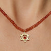 Orange sapphire matte sacral necklace with 18K yellow gold hammered pendant, fire opal center, and 36.5-carat graduated faceted orange sapphire chain, handmade in San Francisco